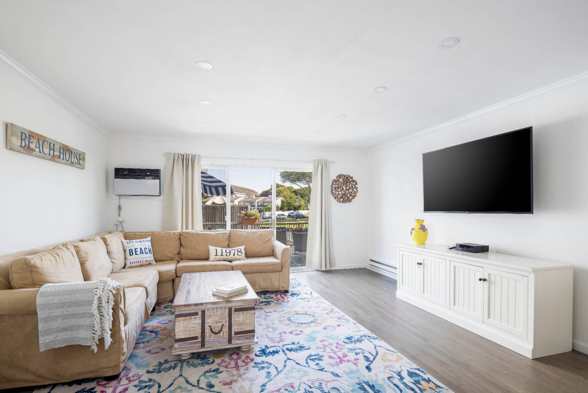 3045 Mitchell Road Westhampton Beach, NY 11978 - Photo 2 of 25 a living room with furniture and a flat screen tv