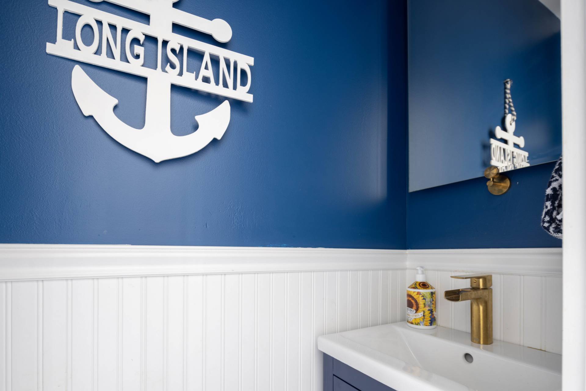 3045 Mitchell Road Westhampton Beach, NY 11978 - Photo 8 of 25 a bathroom with a sink and a mirror