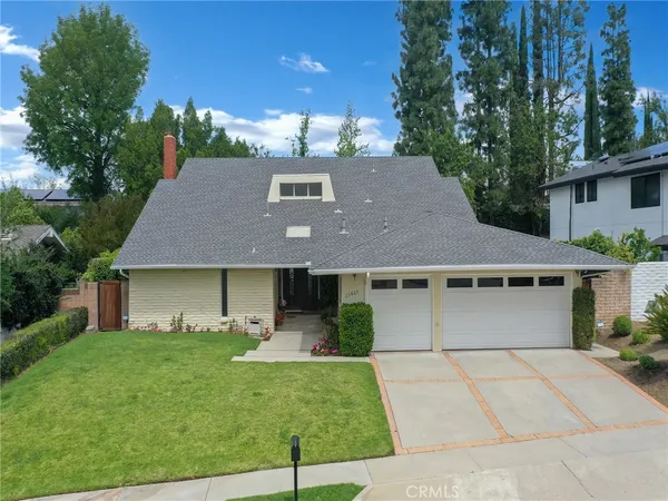 a aerial view of a house next to a yard