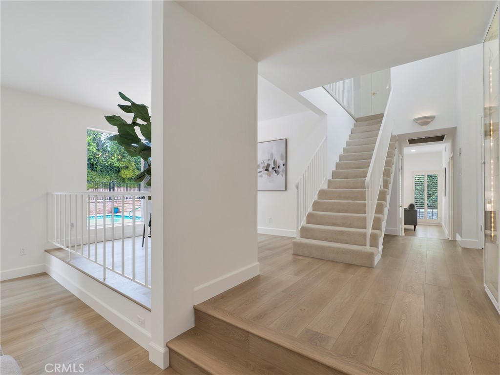 22649 Town Crier Road Calabasas, CA 91302 - Photo 11 of 47 a view of a hallway with staircase