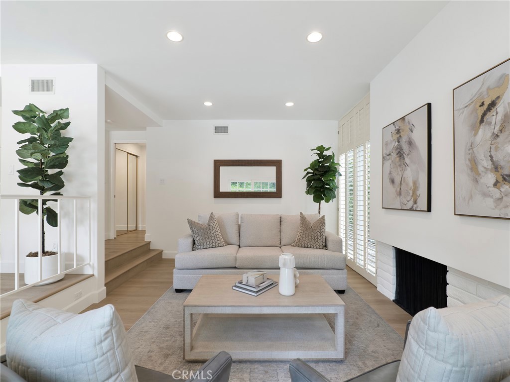 22649 Town Crier Road Calabasas, CA 91302 - Photo 12 of 47 a living room with furniture and a fireplace