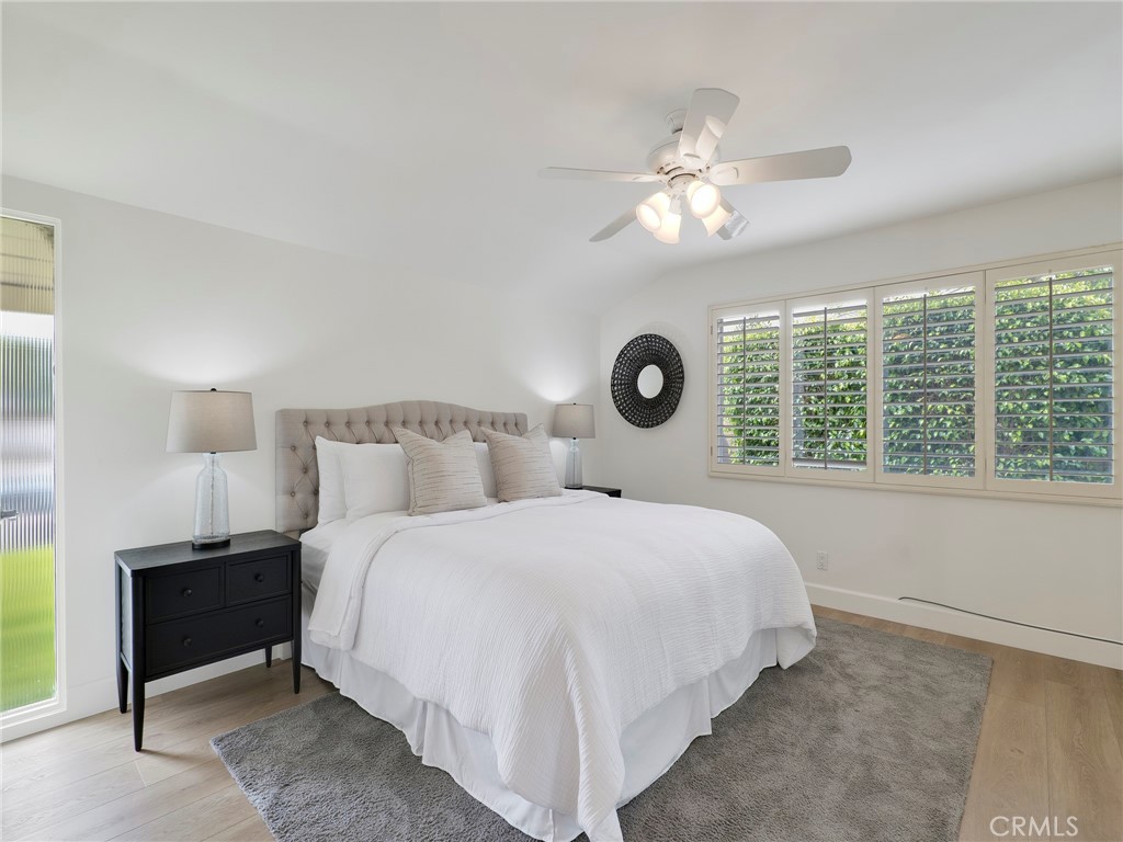 22649 Town Crier Road Calabasas, CA 91302 - Photo 14 of 47 a bedroom with a large bed and a chandelier