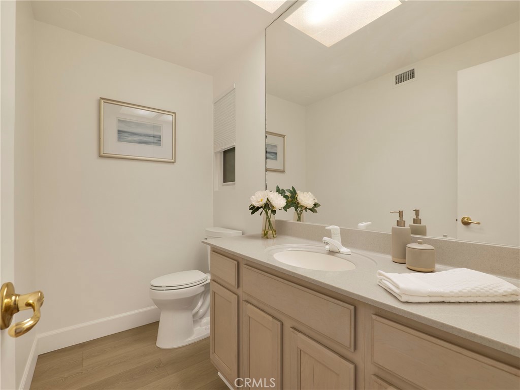 22649 Town Crier Road Calabasas, CA 91302 - Photo 18 of 47 a bathroom with a granite countertop sink and a toilet