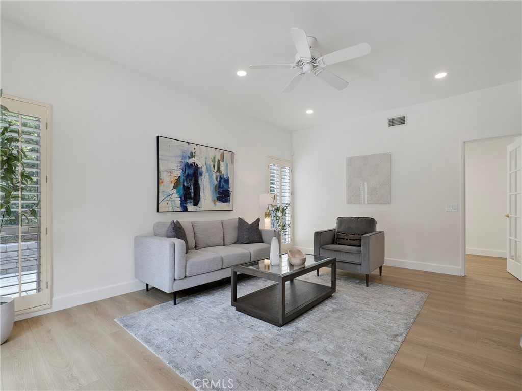 22649 Town Crier Road Calabasas, CA 91302 - Photo 23 of 47 a living room with furniture and a ceiling fan