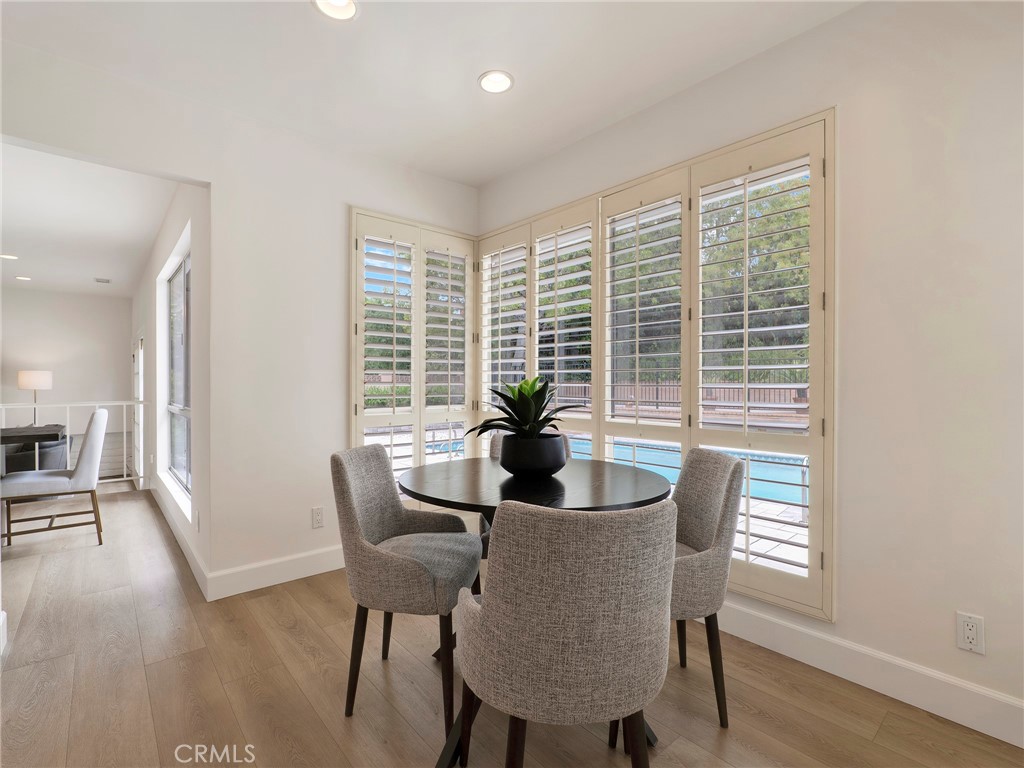 22649 Town Crier Road Calabasas, CA 91302 - Photo 25 of 47 a dining room with furniture and wooden floor
