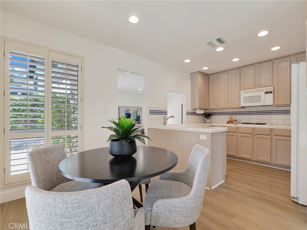 22649 Town Crier Road Calabasas, CA 91302 - Photo 26 of 47 a kitchen with a table and chairs