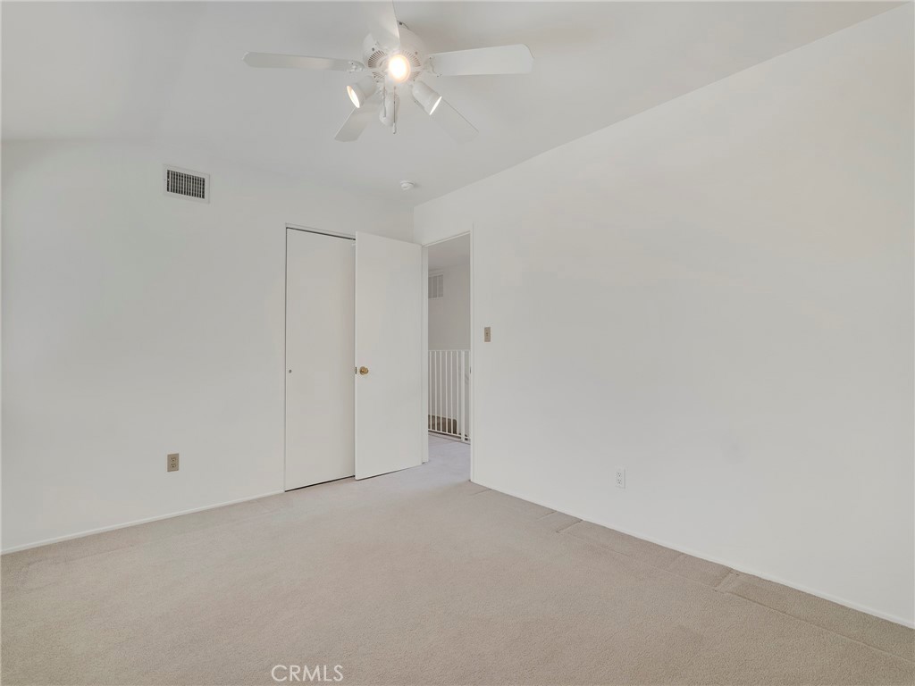 22649 Town Crier Road Calabasas, CA 91302 - Photo 35 of 47 an empty room with a ceiling fan and a window