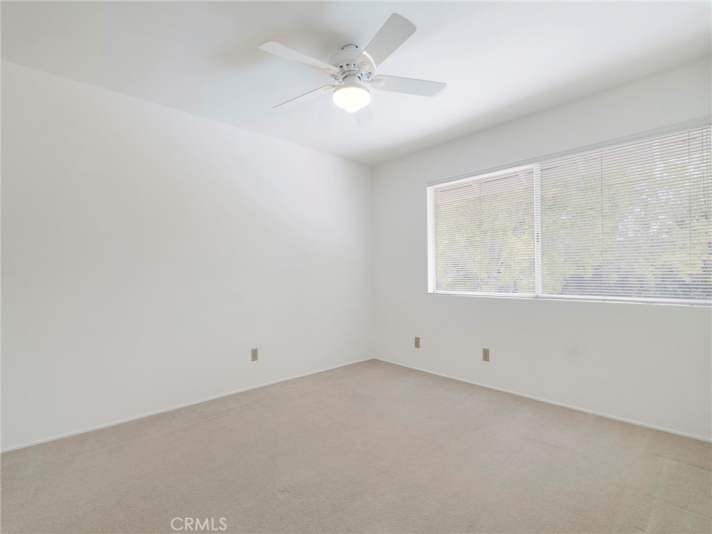 22649 Town Crier Road Calabasas, CA 91302 - Photo 36 of 47 an empty room with a window and a ceiling fan
