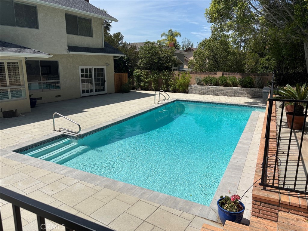 22649 Town Crier Road Calabasas, CA 91302 - Photo 38 of 47 a view of a terrace with couches and swimming pool