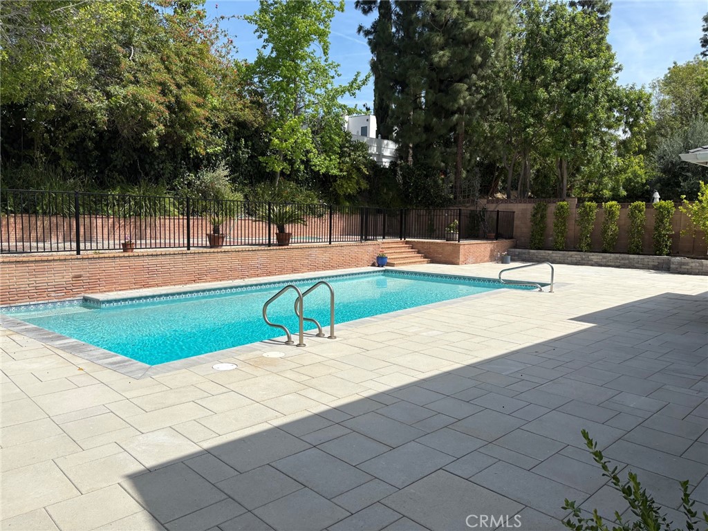 22649 Town Crier Road Calabasas, CA 91302 - Photo 40 of 47 a swimming pool with an outdoor space and seating area