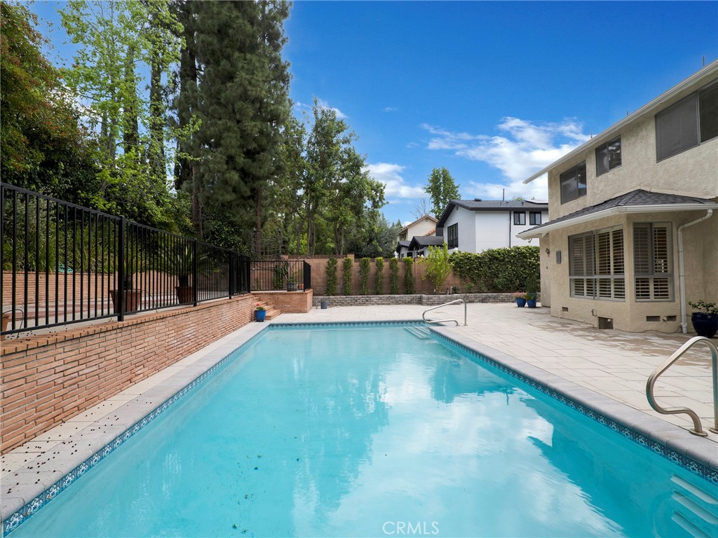 22649 Town Crier Road Calabasas, CA 91302 - Photo 43 of 47 a view of a house with swimming pool and sitting area