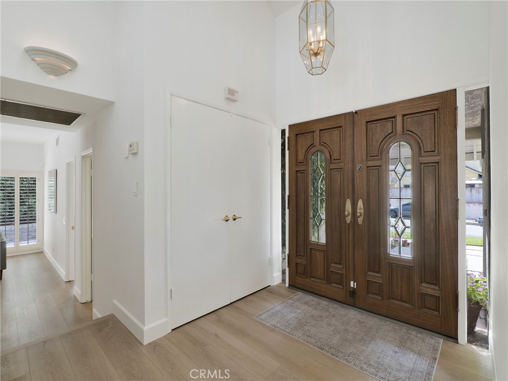 22649 Town Crier Road Calabasas, CA 91302 - Photo 5 of 47 an empty room with windows wooden floor and door