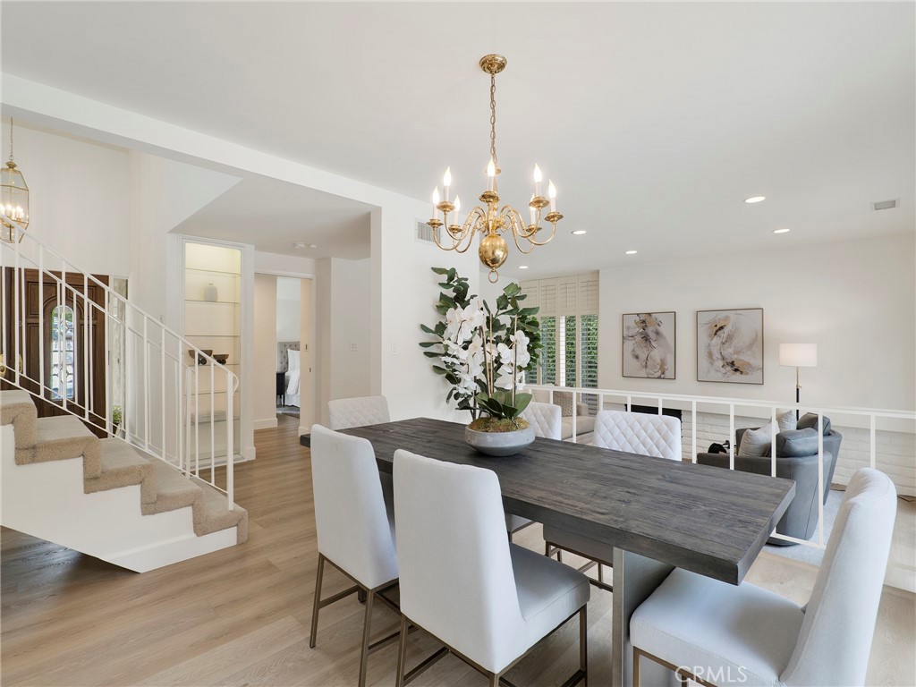 22649 Town Crier Road Calabasas, CA 91302 - Photo 7 of 47 a view of a dining room with furniture and wooden floor