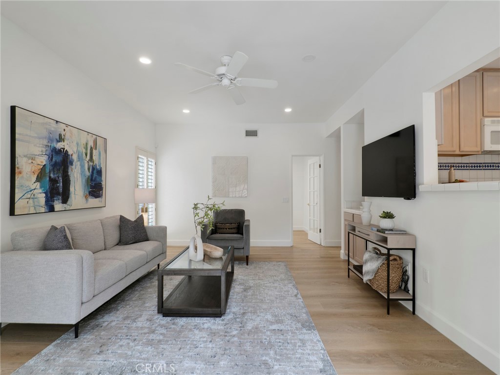 22649 Town Crier Road Calabasas, CA 91302 - Photo 8 of 47 a living room with furniture and a flat screen tv