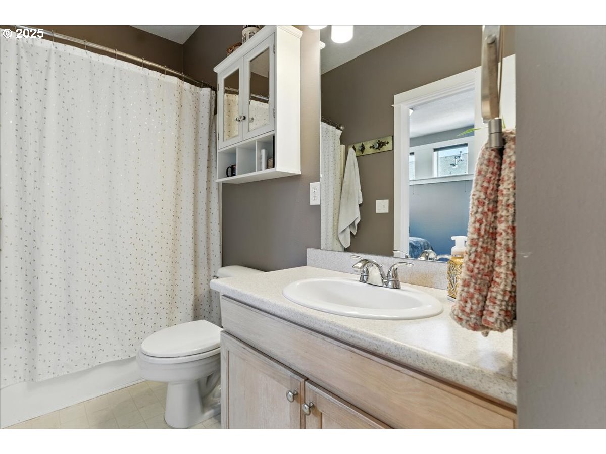 1443 Northeast Village Street Fairview, OR 97024 - Photo 27 of 37 a bathroom with a sink a toilet and shower