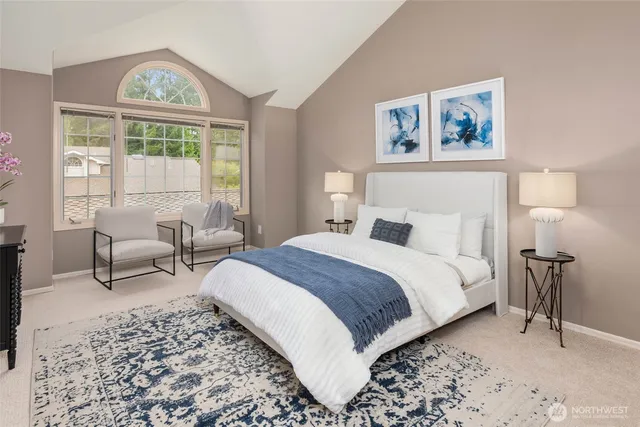 a bedroom with a bed and a large window