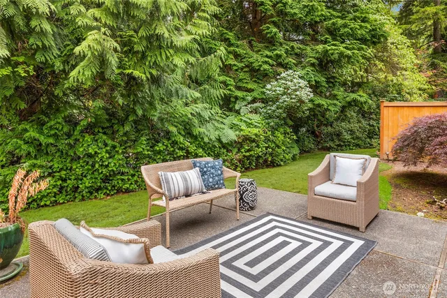 a view of a patio with couches chairs and a yard