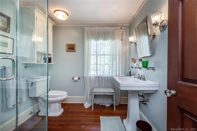 a bathroom with a sink toilet and a mirror