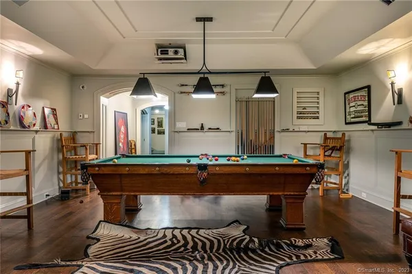 a living room with furniture a flat screen tv and kitchen view