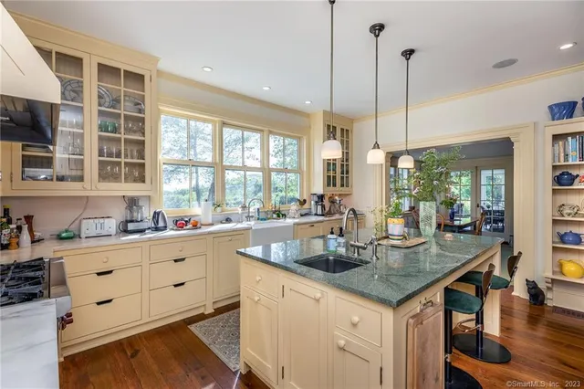 a kitchen with sink cabinets and wooden floor