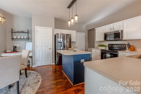 a kitchen with sink a refrigerator and cabinets