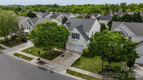 an aerial view of a house with a yard and outdoor seating