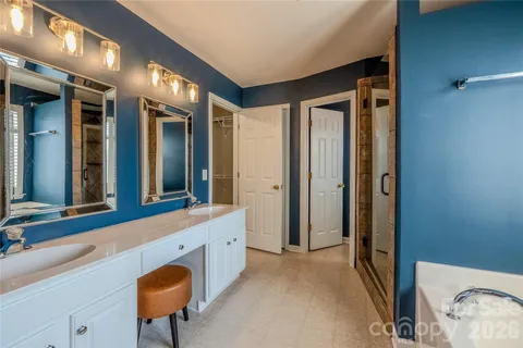 a bathroom with a sink a mirror and a bathtub