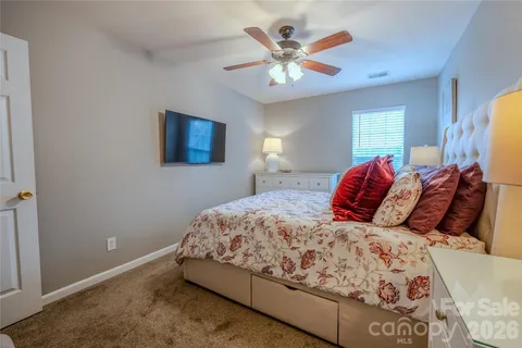 a bedroom with a large bed and a window