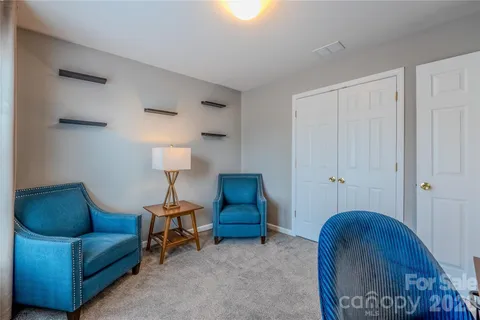 a living room with furniture and a lamp