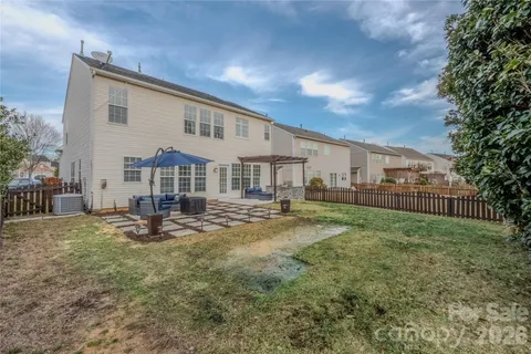 a view of a house with backyard and sitting area