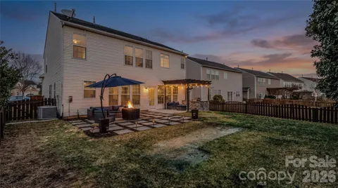 a backyard of a house with yard fire pit and outdoor seating
