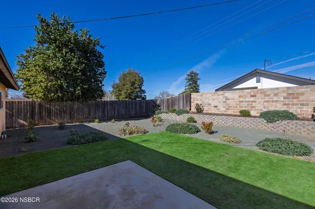 a backyard of a house with yard and outdoor seating