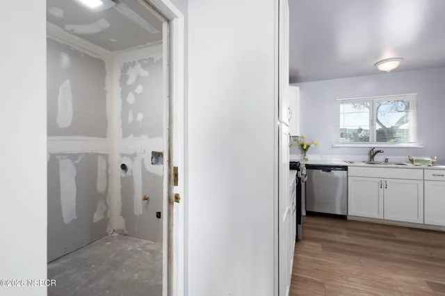 a kitchen with a refrigerator and a stove top oven