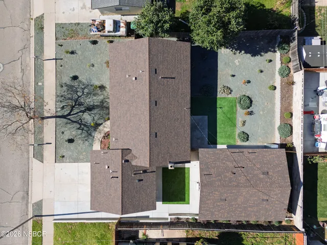 an aerial view of residential houses with outdoor space