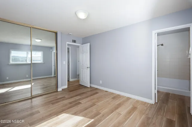 a view of a kitchen with a sink and a refrigerator