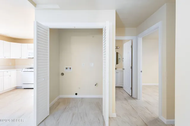 an empty room with windows and closet