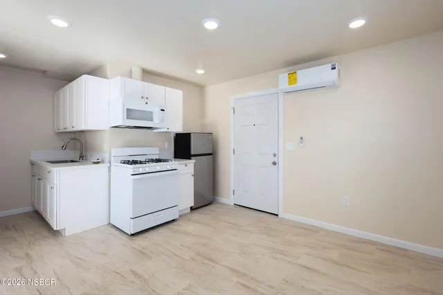 a bathroom with a toilet a sink a mirror and vanity