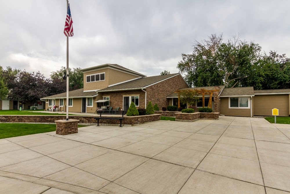 a front view of a house with sitting area