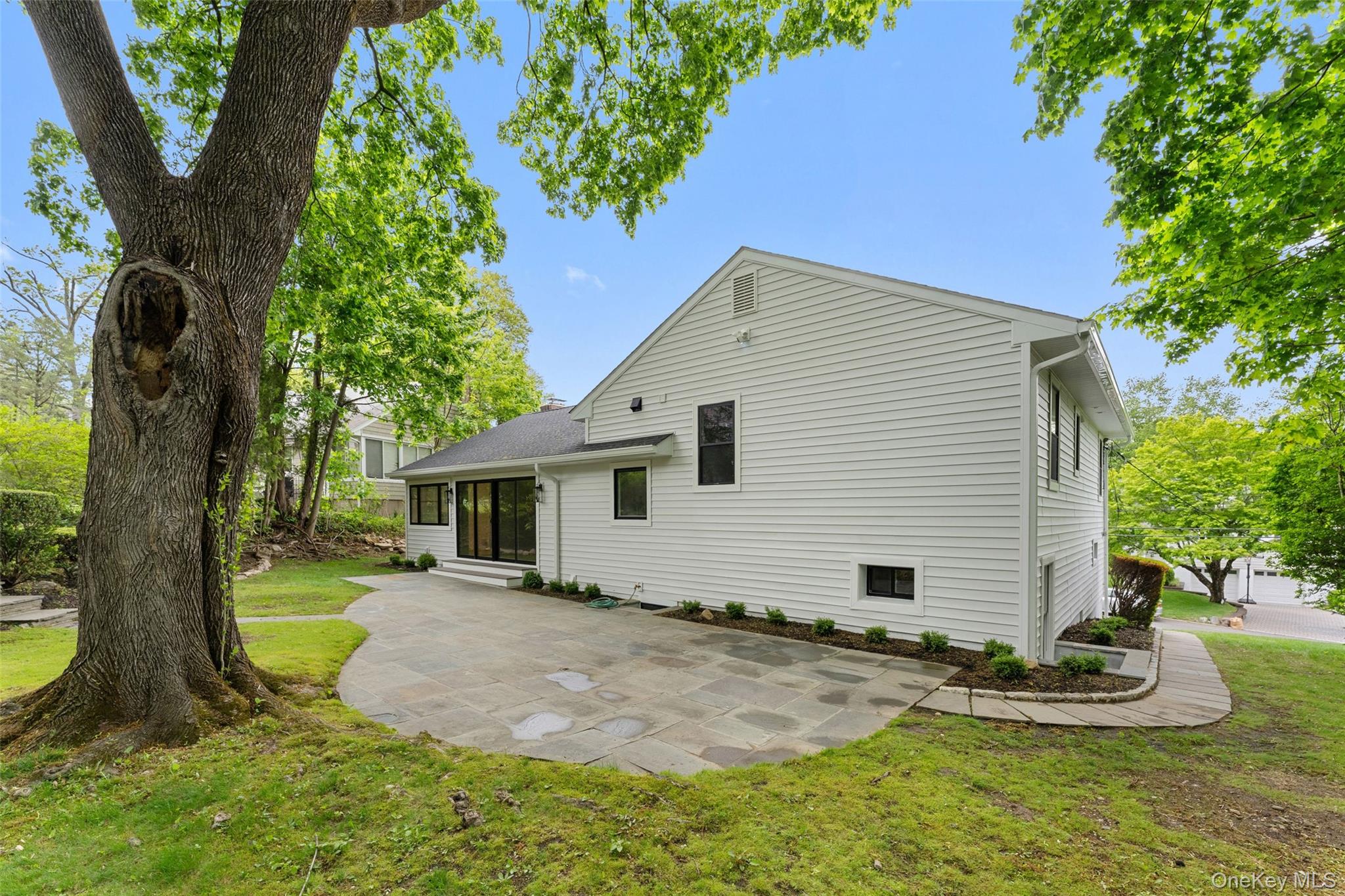 153 Waverly Road Scarsdale, NY 10583 - Photo 35 of 44 Back patio and sliding glass doors with entry to home