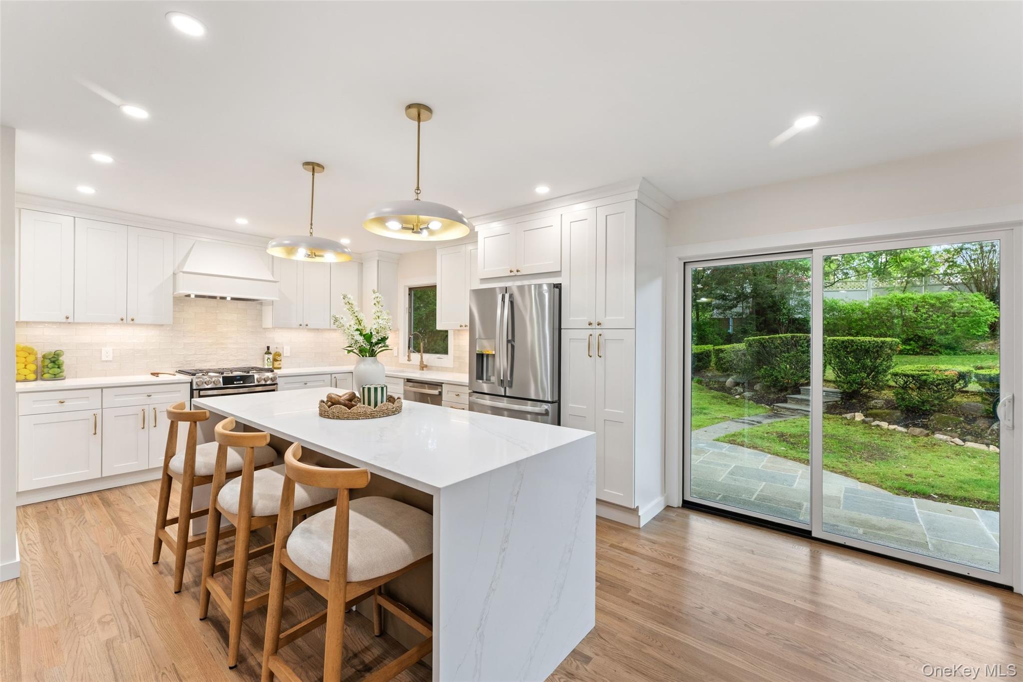 153 Waverly Road Scarsdale, NY 10583 - Photo 8 of 44 Open Kitchen with waterfall quartz island and brand new GE Profile appliances