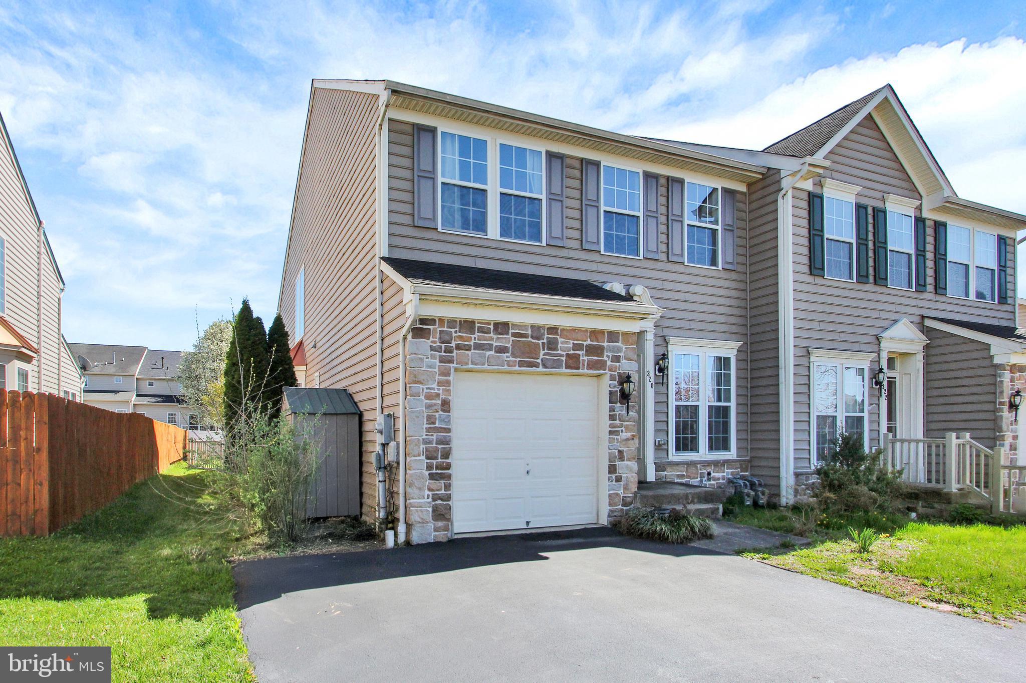 320 Maple Drive Hanover, PA 17331 - Photo 2 of 23 a front view of a house with a yard and garage