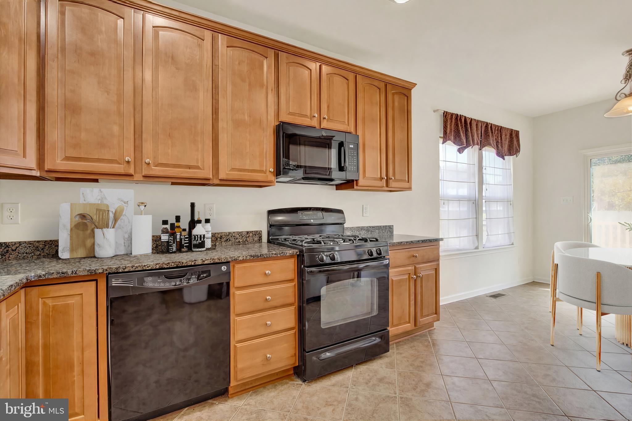 320 Maple Drive Hanover, PA 17331 - Photo 5 of 23 a kitchen with stainless steel appliances granite countertop a stove a sink and a microwave