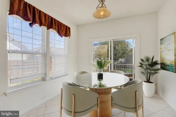 a dining room with furniture and wooden floor