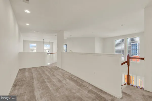 a view of empty room with wooden floor and window