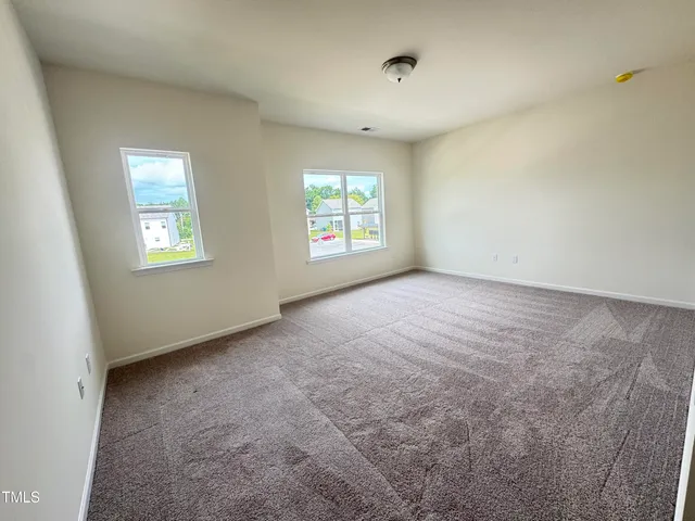 a view of an empty room with windows