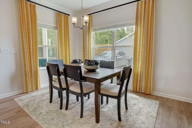 a dining room with furniture and window