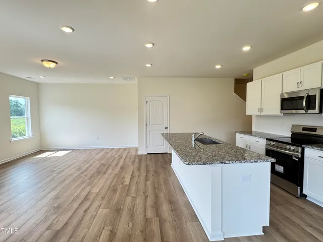 a kitchen with a sink and a stove top oven