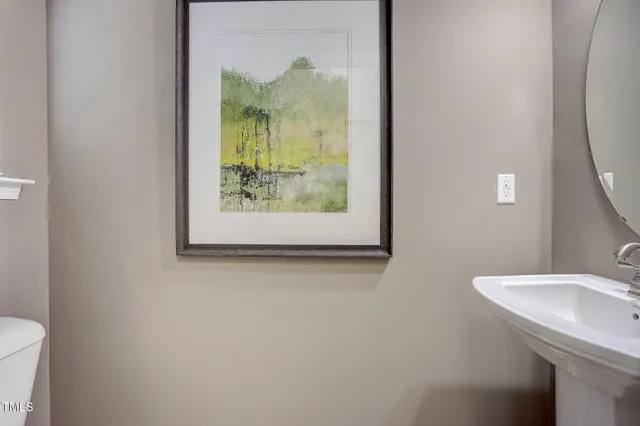 a large kitchen with stainless steel appliances wooden floors and wooden cabinets