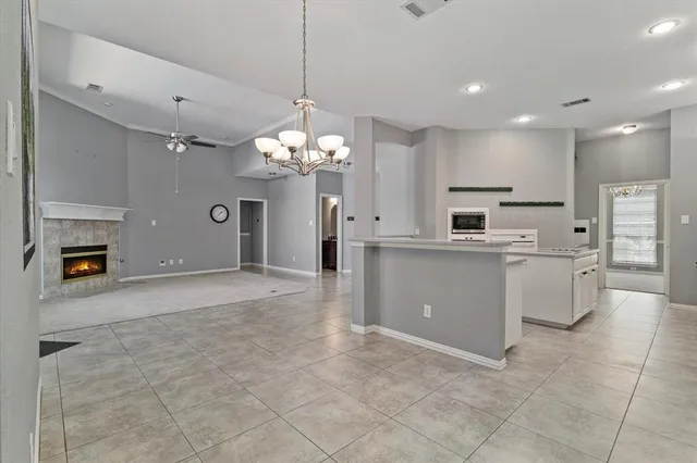a large white kitchen with a chandelier