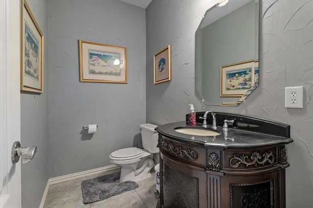 a bathroom with a sink toilet and a mirror